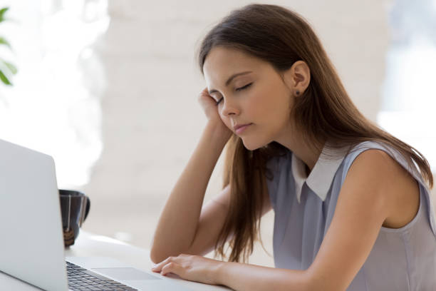 istock Exhausted young female fall asleep at workplace 1227089188