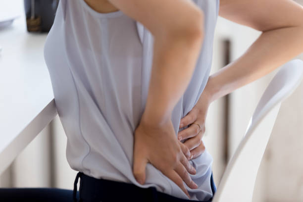 istock Close up of female employee suffer from lower back ache 1227089197