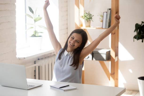 istock Happy female employee stretch exercise at workplace 1227089219