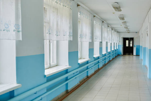 istock a public school, a long empty corridor with blue walls. The concept of quarantine 1227089466