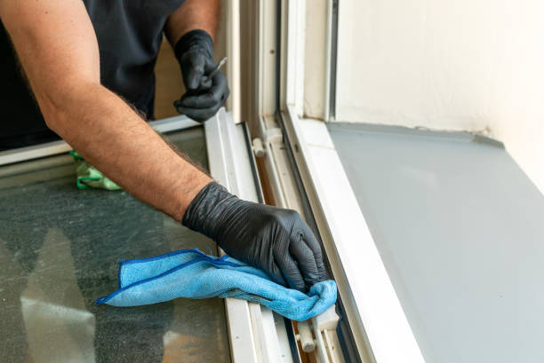istock profesional cleaner cleaning a dirty window frame with a micro fiber cloth 1227089604