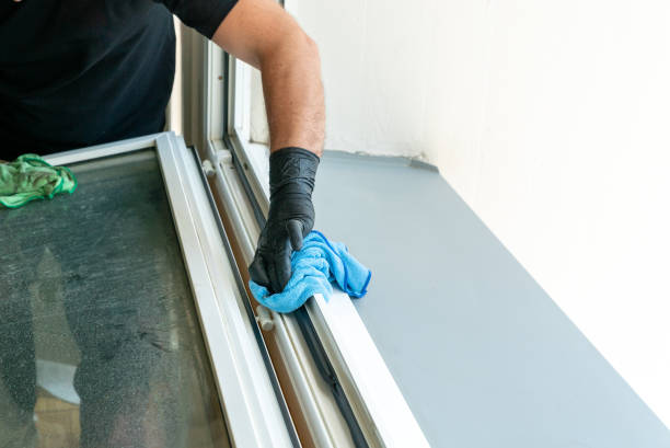 istock profesional cleaner cleaning a dirty window frame with a micro fiber cloth 1227089655