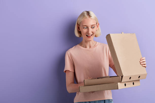 istock excited surprised girl opening pizza box 1227090318
