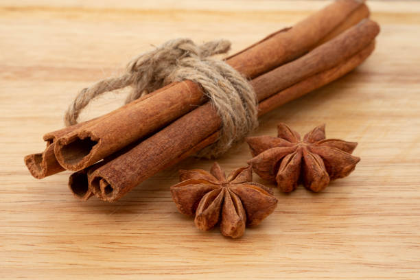 istock Star anise and cinnamon sticks on wooden background. 1227090379