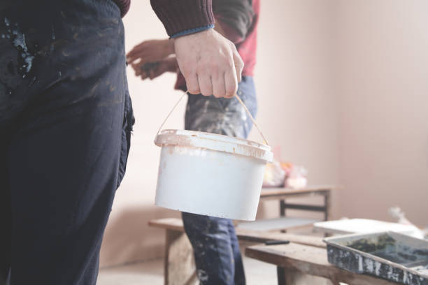 istock Man works at home. Worker with bucket paint. Renovation 1227090707