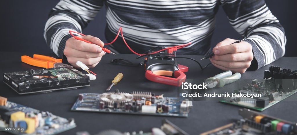 Man Checking Computer Motherboard With A Multimeter Stock Photo ...