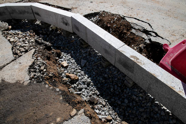 istock Setting road border before laying asphalt. Reconstruction of the sidewalk and replacement of old curbs. Road infrastructure repair 1227090919