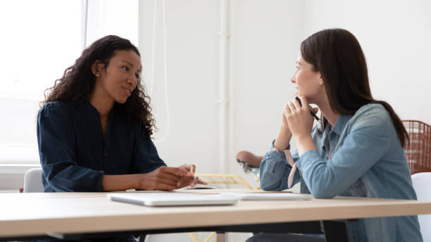 istock Smiling female employer consider job candidate at interview 1227091028