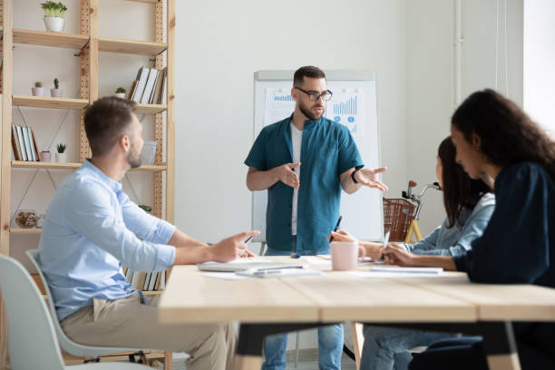 istock Confident male leader head office meeting with colleagues 1227091068