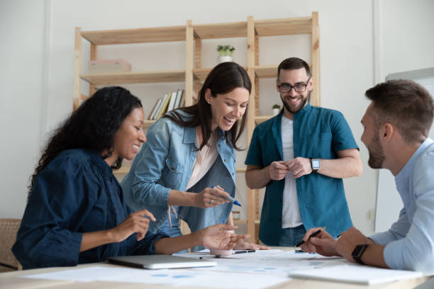 istock Happy multiracial coworkers have fun brainstorming at briefing 1227091071