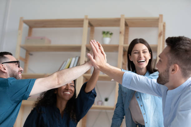 istock Happy colleagues give high five celebrating business win 1227091083