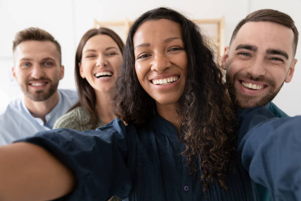 istock Smiling diverse colleagues take selfie in office together 1227091091