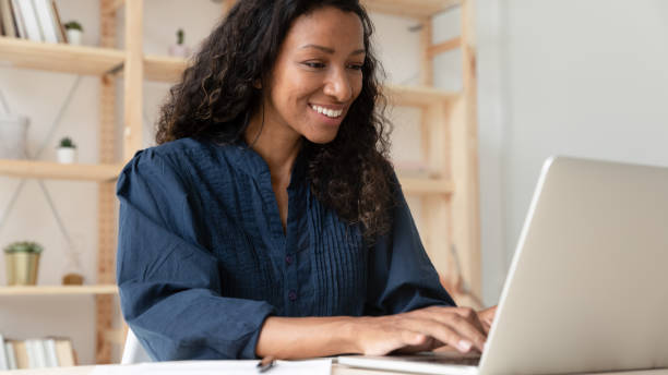 istock Smiling biracial female employee work on laptop at workplace 1227091099