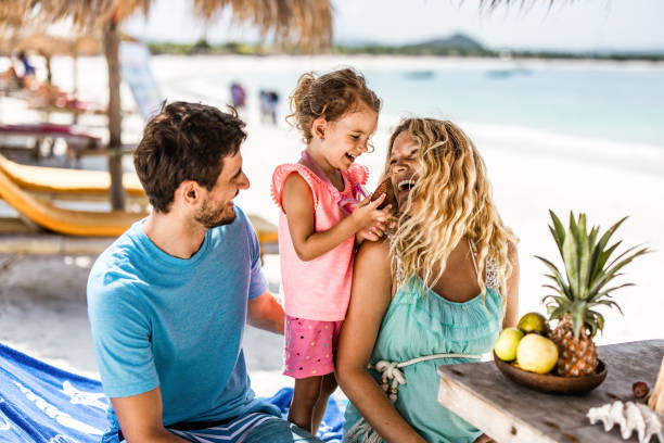 istock Young happy family communicating on a deck chair at beach. 1227091999