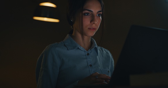 Portrait of a beautiful young girl while doing smart working in the living room of her house.