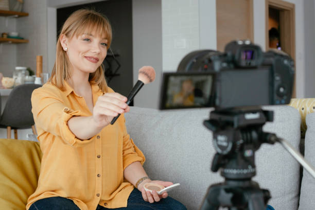 istock Young beautiful woman recording make up tutorial to share on social media. 1227093129