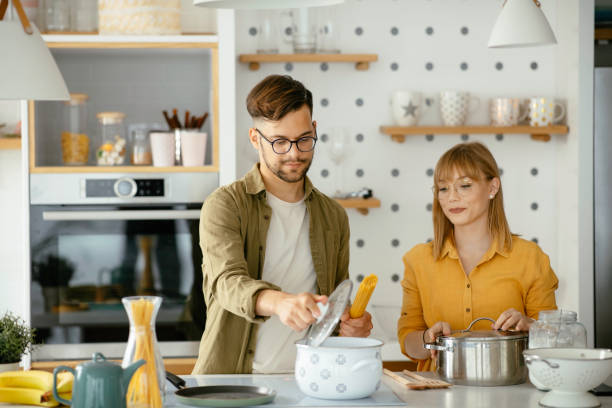 istock Young couple cooking together at home 1227093190