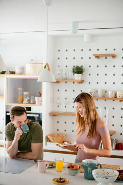 istock Young couple making breakfast at home. 1227093245