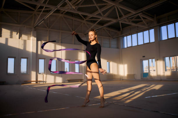 istock Rhythmic gymnast with ribbon in bark gym 1227093483