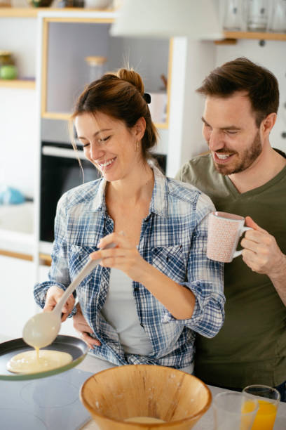 istock Young couple making pancakes at  home. 1227093495