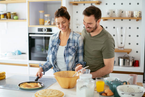 istock Young couple making pancakes at  home. 1227093528