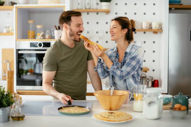 istock Young couple making pancakes at  home. 1227093683