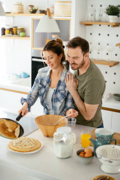 istock Young couple making pancakes at  home. 1227093731