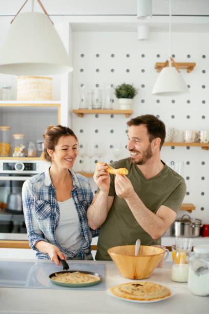 istock Young couple making pancakes at  home. 1227093736