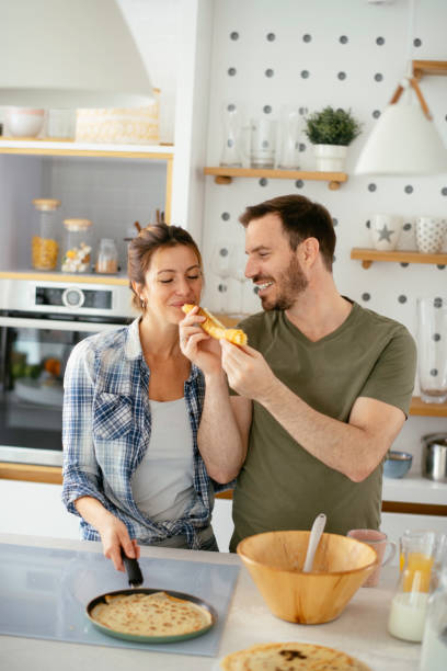 istock Young couple making pancakes at  home. 1227093889