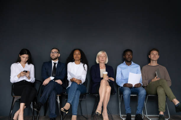 istock Confident diverse business people sitting on chairs in row 1227094259