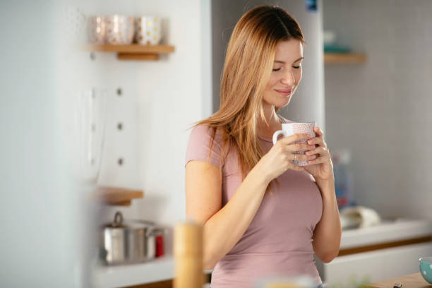 istock Beautiful woman drinking coffee and eating breakfast 1227094673