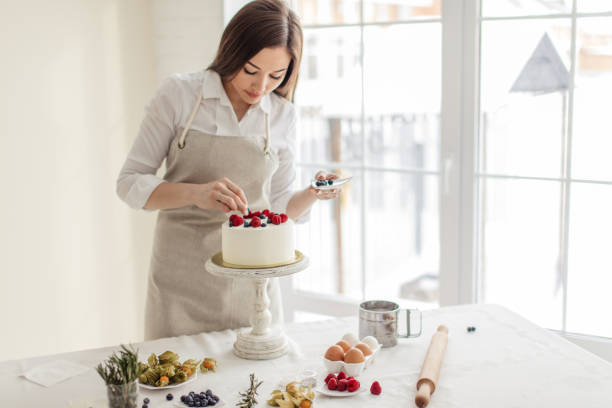 istock attractive girl selecting fresh berries for cake 1227094885