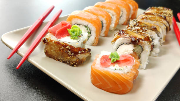 istock sushi on a plate with a black background 1227095023