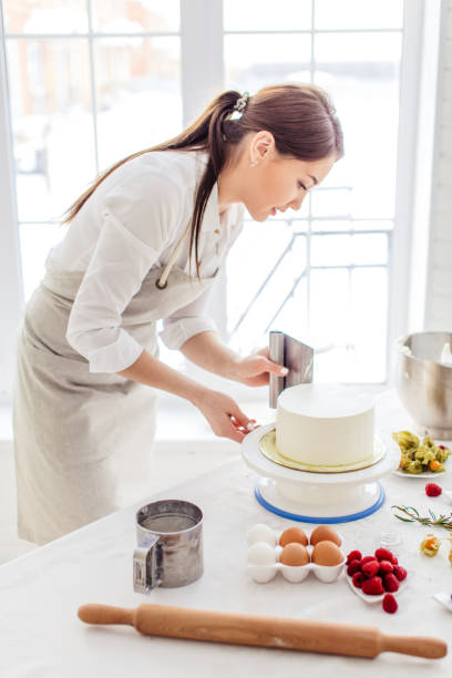 istock hardworking girl giving smooth edges to cake 1227095059