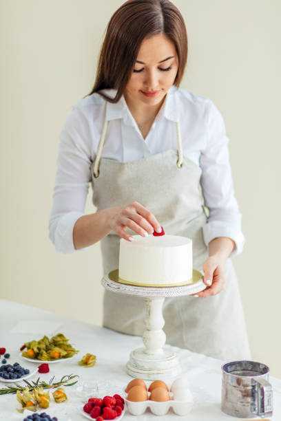 istock female chef preparing a sweet cake with raspberries 1227095225