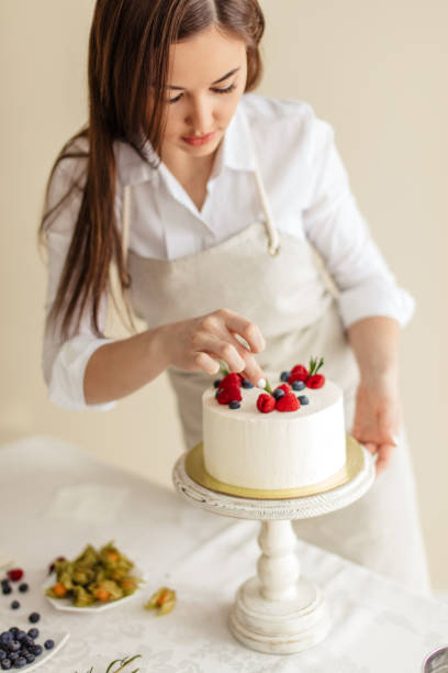 istock woman using seasonal berries for decoration in the kitchen 1227095279