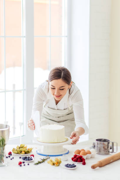 istock beautiful girl gets pleasure from cooking cake 1227095290