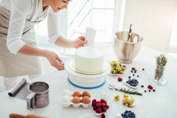 istock perfect smooth. chef holding a bench scraper vertically agains the cake 1227095437