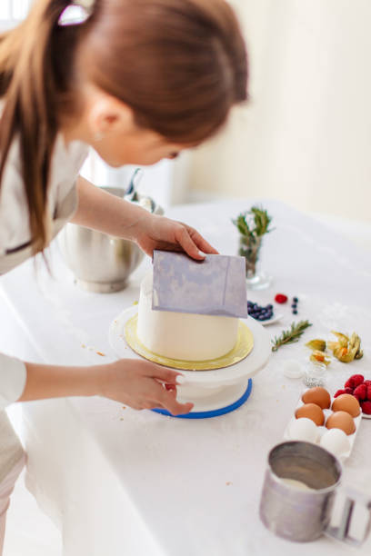 istock awesome girl spinning the cake while smooting it 1227095500
