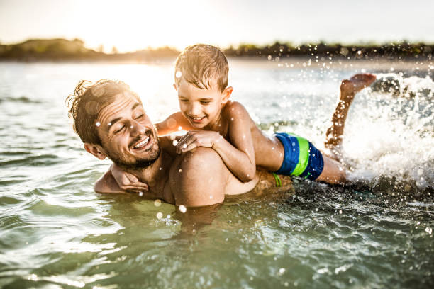 istock Happy single father and son having fun in summer day at sea. 1227095761