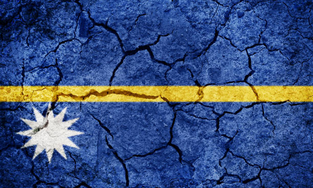 Republic of Nauru flag on dry earth ground texture background