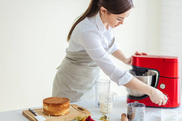 istock Young Asian woman using a mixer in the kitchen room 1227096448