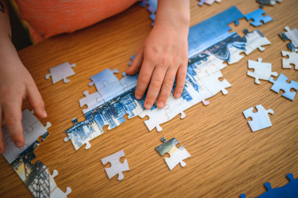 istock Boy collecting puzzles on the table 1227097138