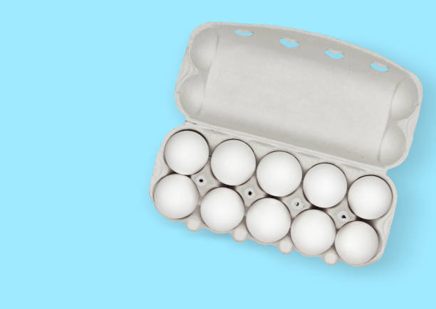 istock Top view of a ten white chicken eggs in a cardboard box 1227098140