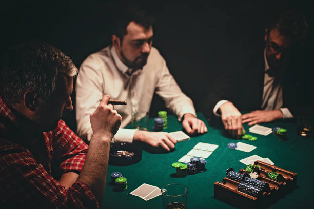 istock Men playing poker late by night 1227099054