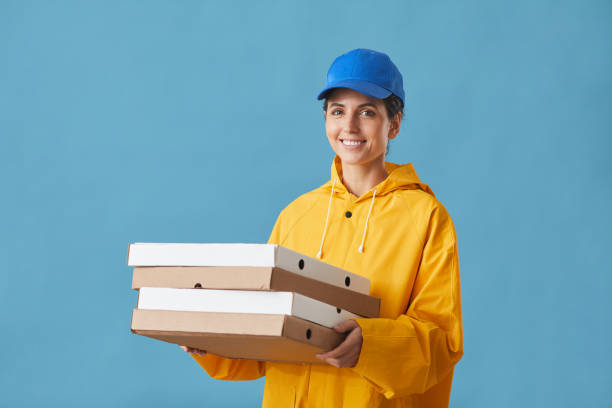 istock Woman delivering pizza 1227099185