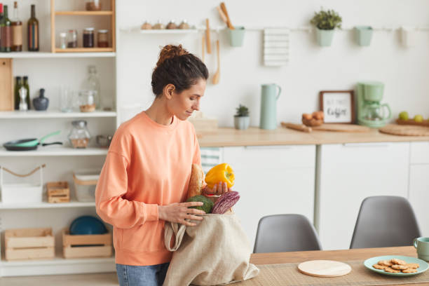 istock Woman unpacking the products 1227099325