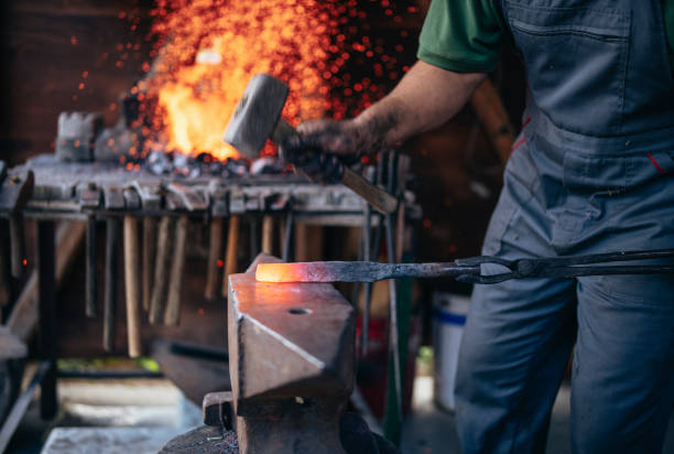 istock Craftsman forges molten metal on an anvil. 1227101264
