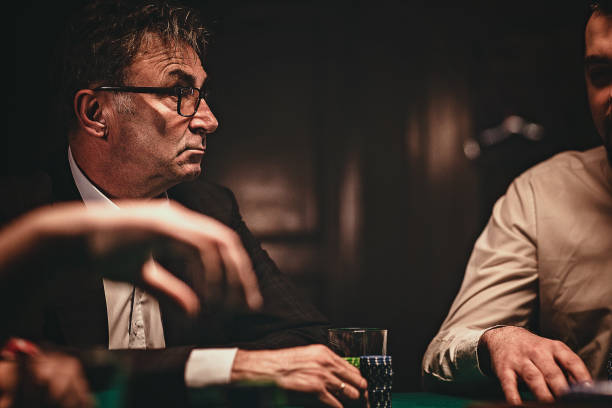 istock Man playing poker late by night 1227101279