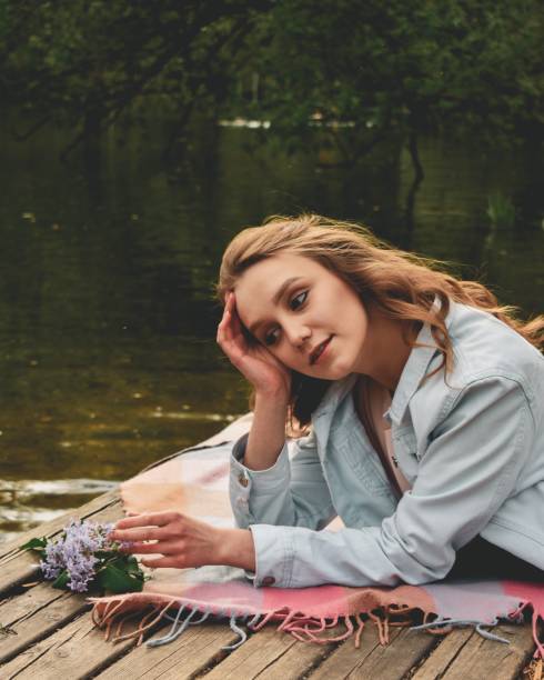Girl with dandelion on a picnic